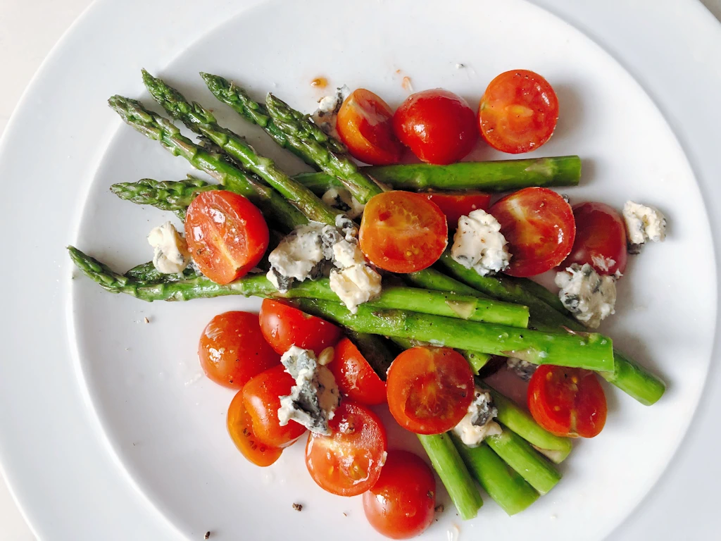 Asparagus blue cheese salad on a white plate