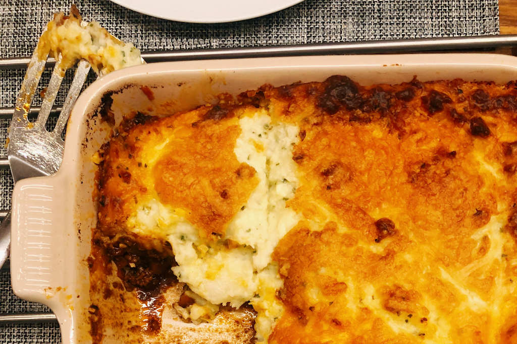 Casserole of Cottage Pie with spatula next to it