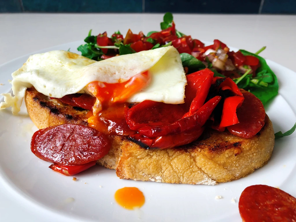 Roasted red pepper and chorizo on toast with egg