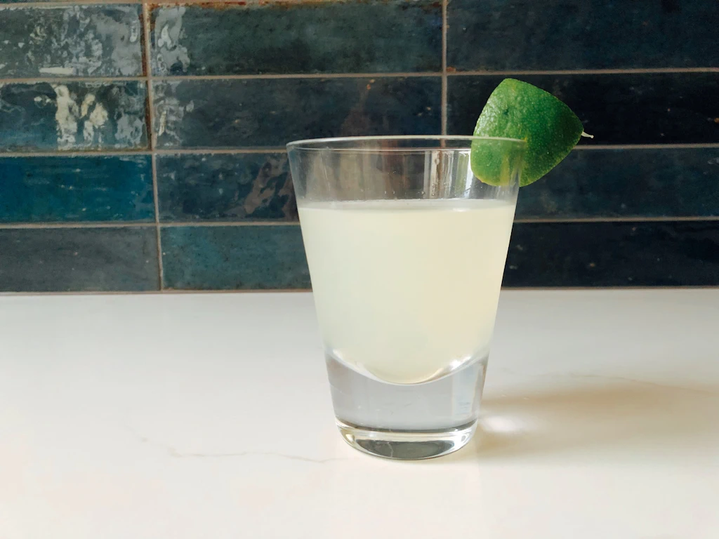 Classic margarita with a chunk of lime wedge on the rim