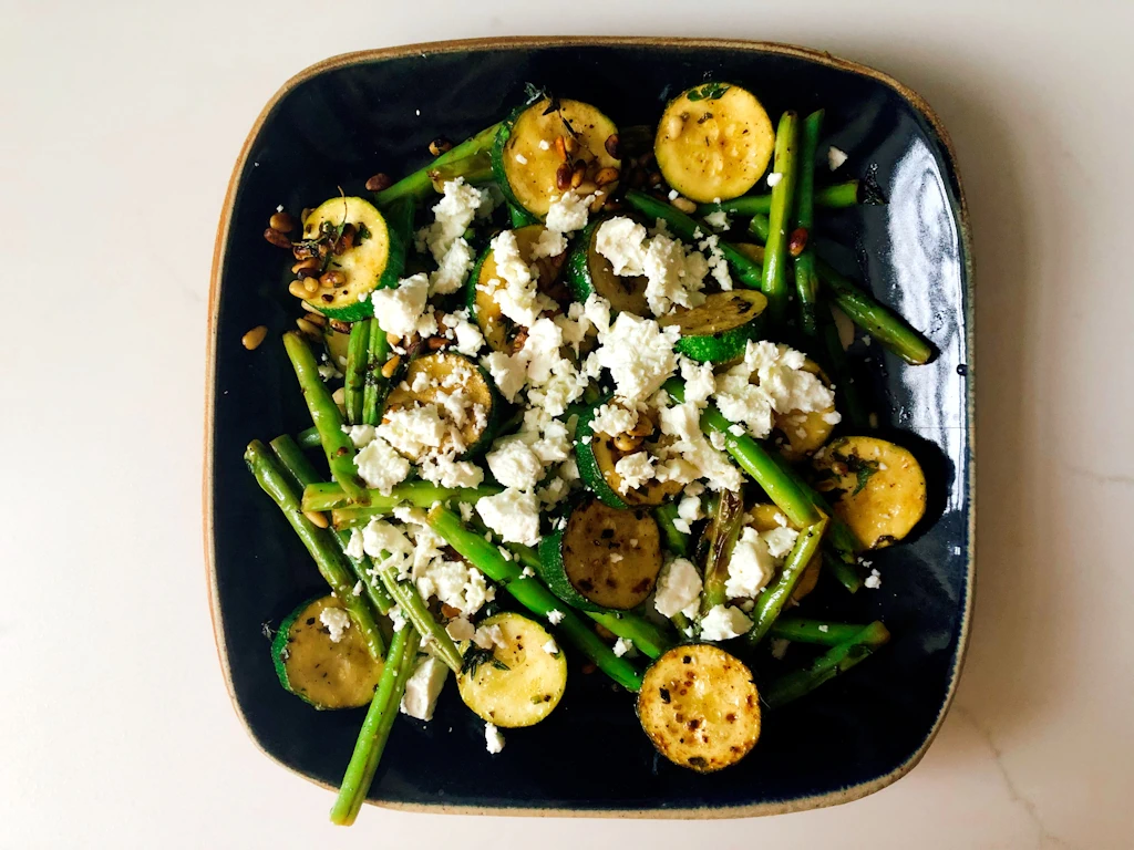 Square plate of courgette green bean salad