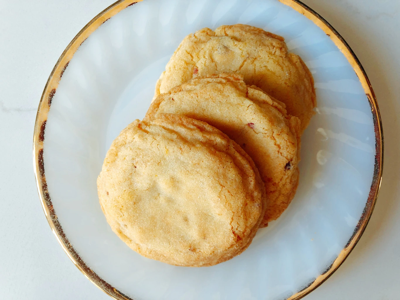 Gold rimmed plate with three pannetone sugar cookies