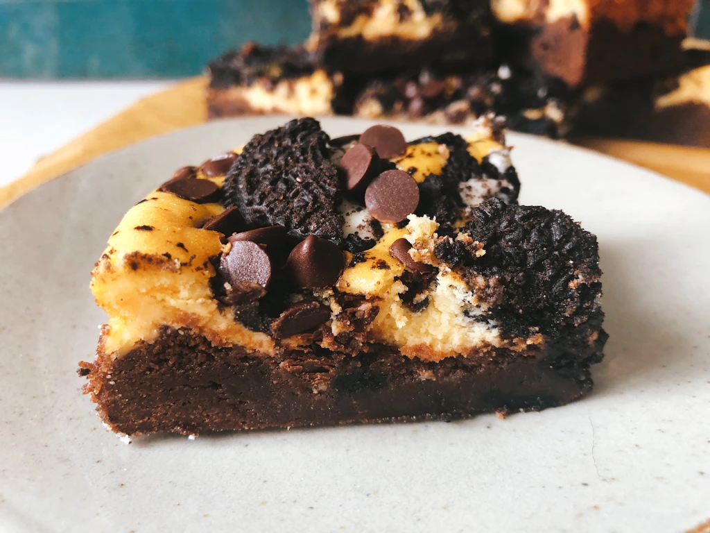 Recipe for Oreo Cheesecake Brownies on a plate